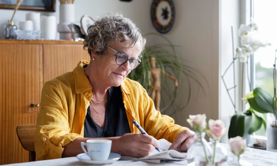 Image of Gullborg sitting in at her table with a coffee and newspaper. Bladder issues are not uncommon when living with MS. In fact, more than 4 in 5 people living with MS are affected by continence challenges at some point in their life. 